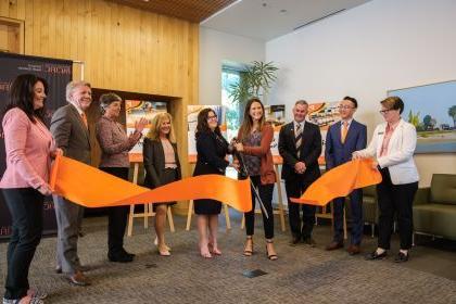 Students, faculty and university leaders hold a ribbon cutting ceremony