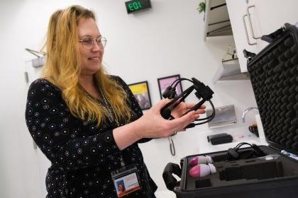 Gabriella Musacchia holds a headset used for audiology research